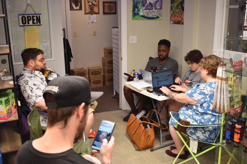Community members working on personal and business related projects during a Chaos Club creative gathering located at Off the Tracks Art Supply, LLC, located in DeKalb, Illinois.